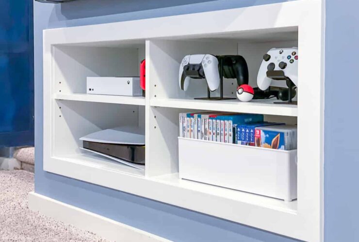 A diverse collection of gaming consoles displayed on a shelf.